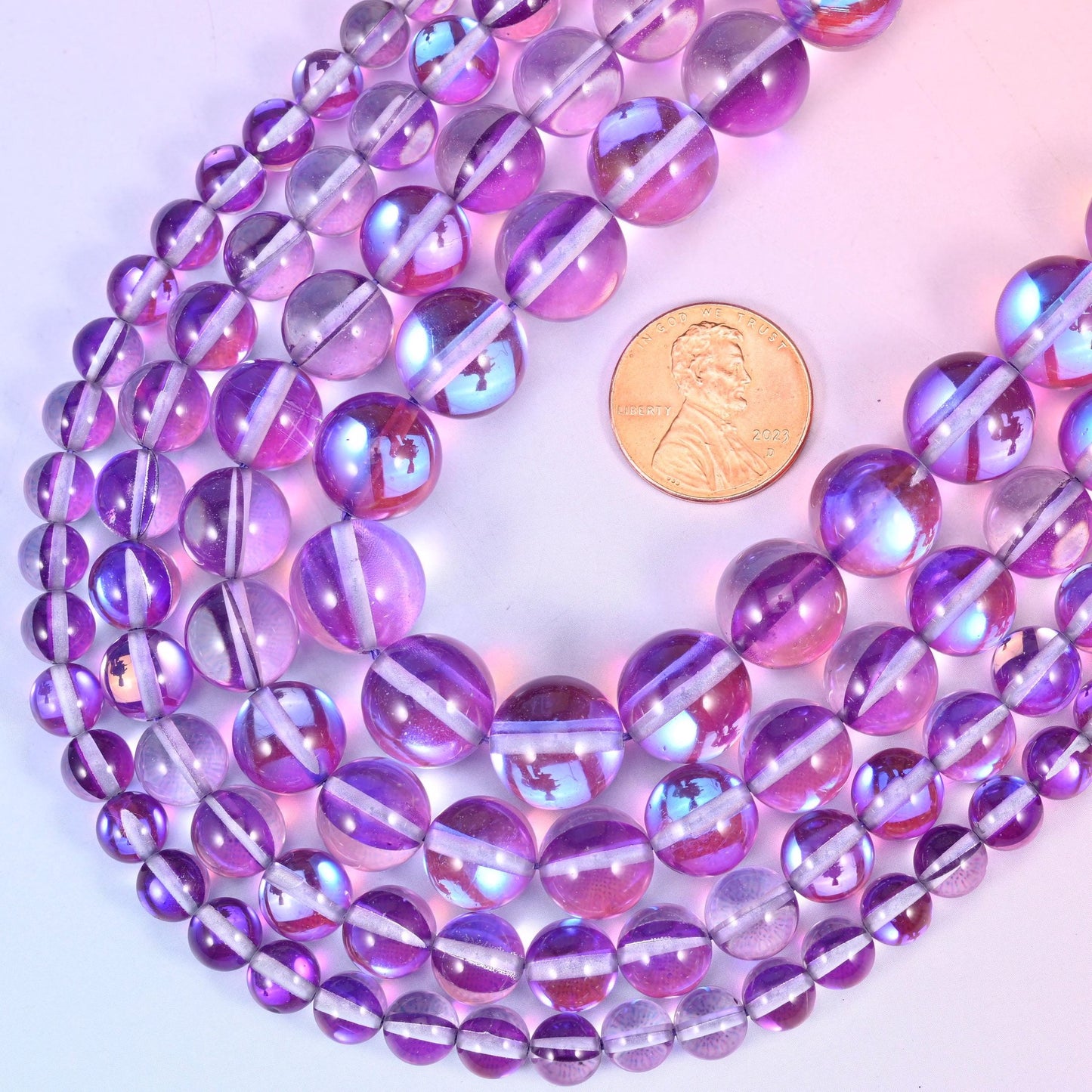 Round iridescent purple glass beads with aurora coated stripe