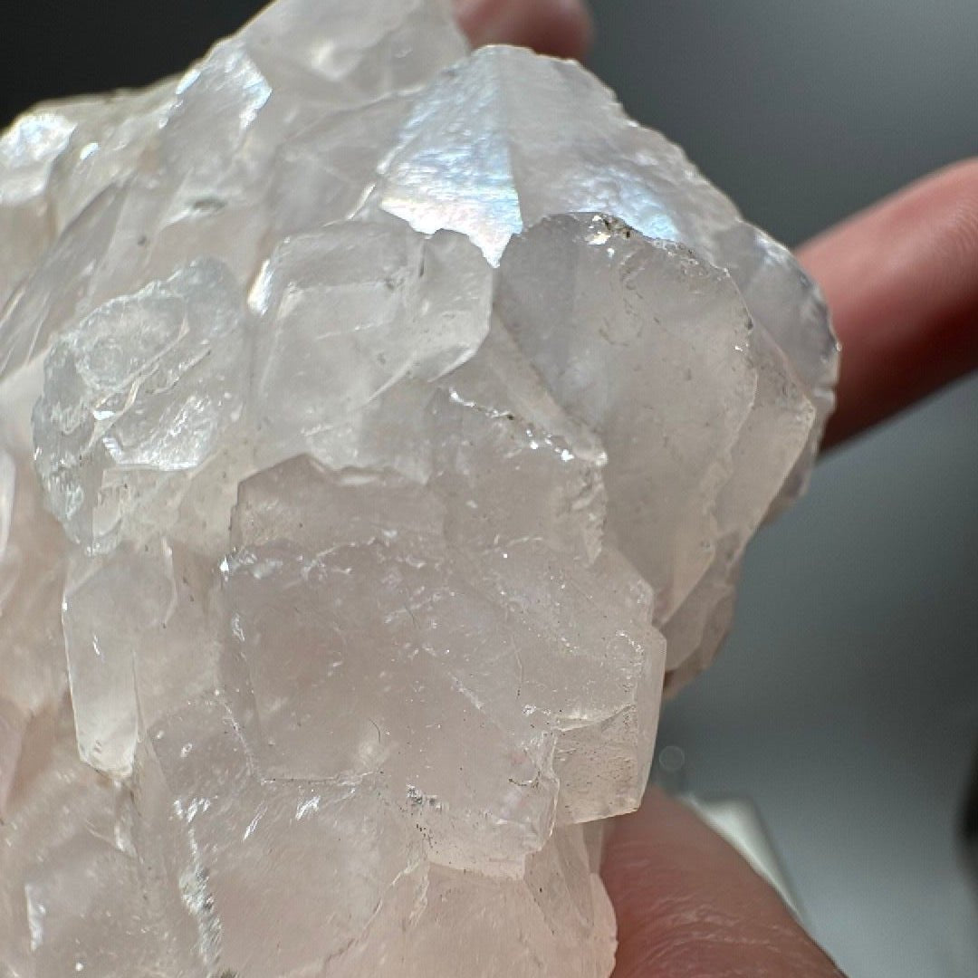 Upper corner of the pink calcite specimen showing pale blush tint in the crystals