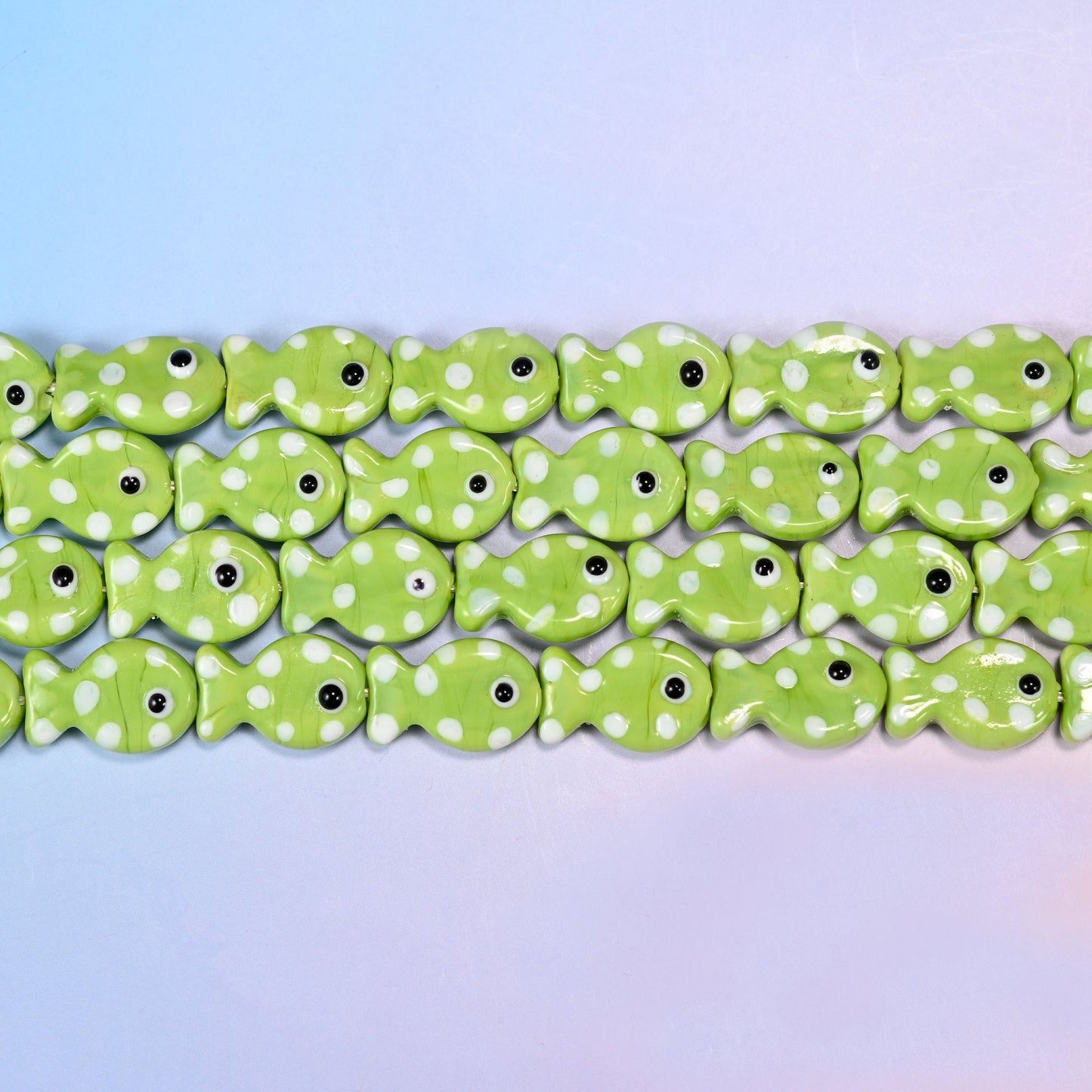 Fish glass beads in opaque apple-lime green with white dots