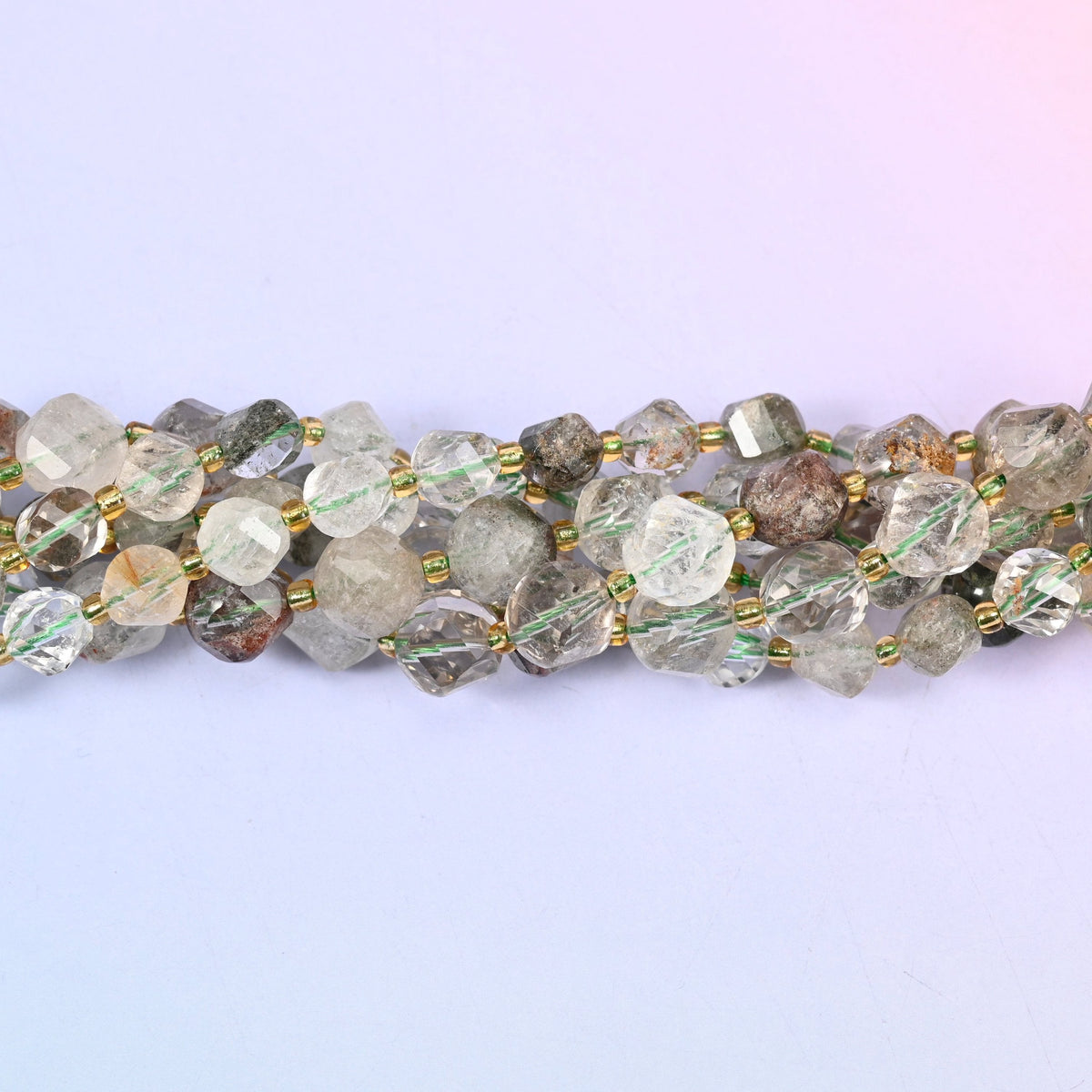 Green Phantom Quartz Faceted Spiral Twist Beads, clear to milky quartz with mossy green and rust-brown phantom inclusions