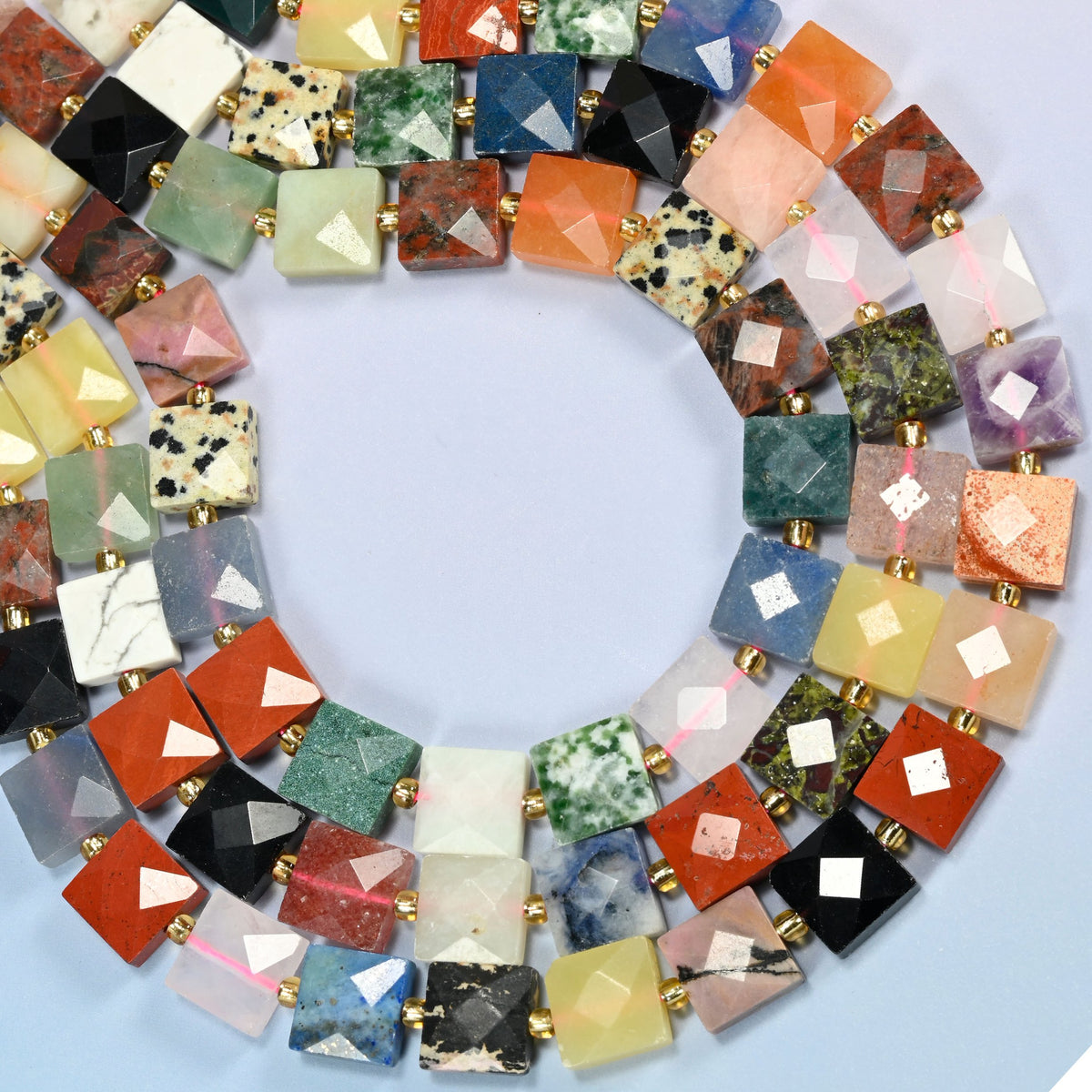 Assorted gemstone faceted flat square beads curved into an open loop, assorted stones in many colors