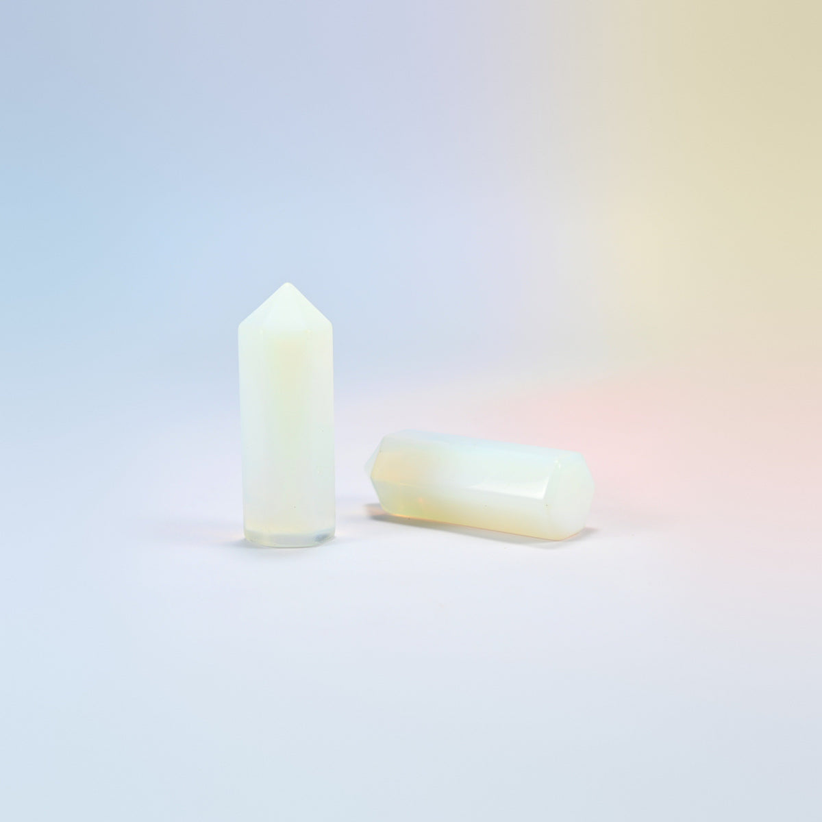 Opalite hexagon points with a milky glow and a soft blue sheen, man-made glass