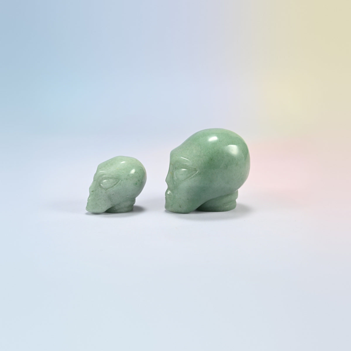 Two green aventurine alien head crystal carvings, 1.5 inch and 2 inch, green natural stone