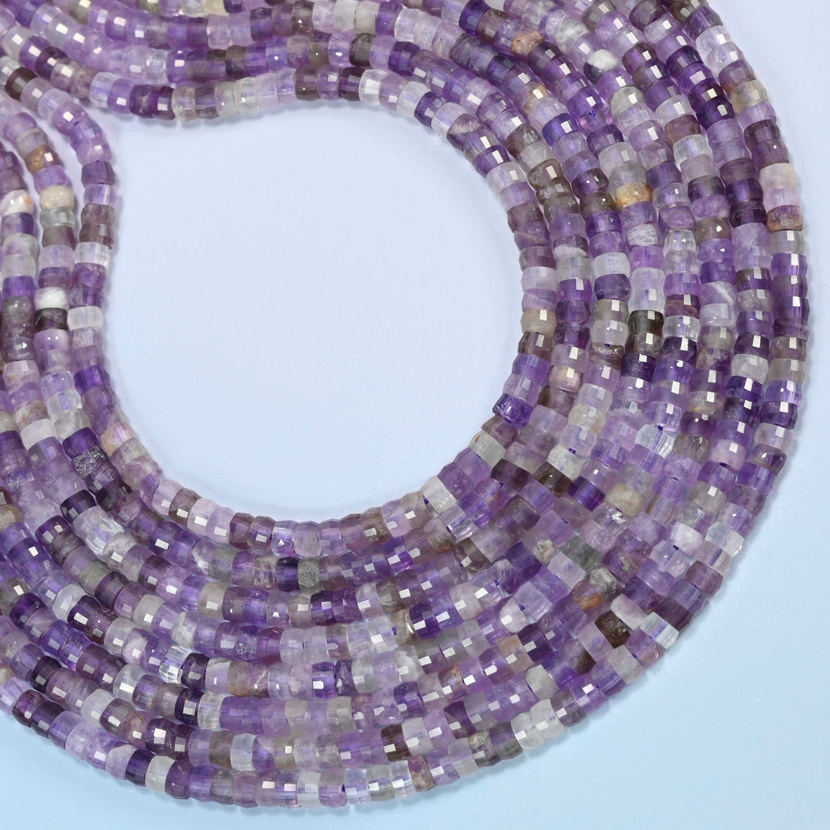 Amethyst faceted heishi disc beads curved into an open loop, purple and light lavender beads