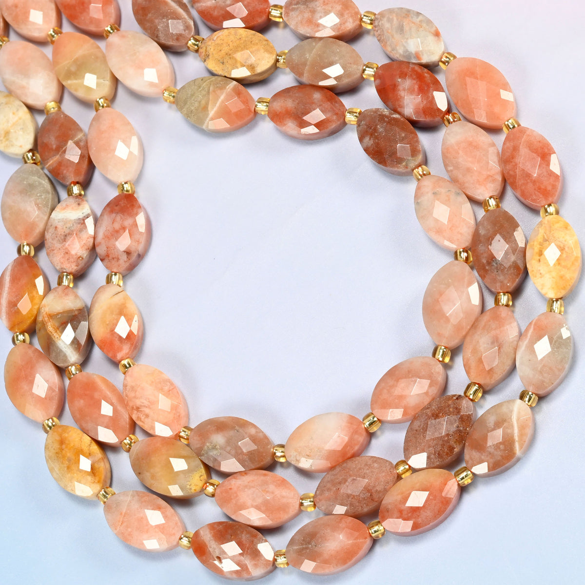 Red crazy agate faceted flat oval beads curved into an open loop, peach, copper and cream banded beads