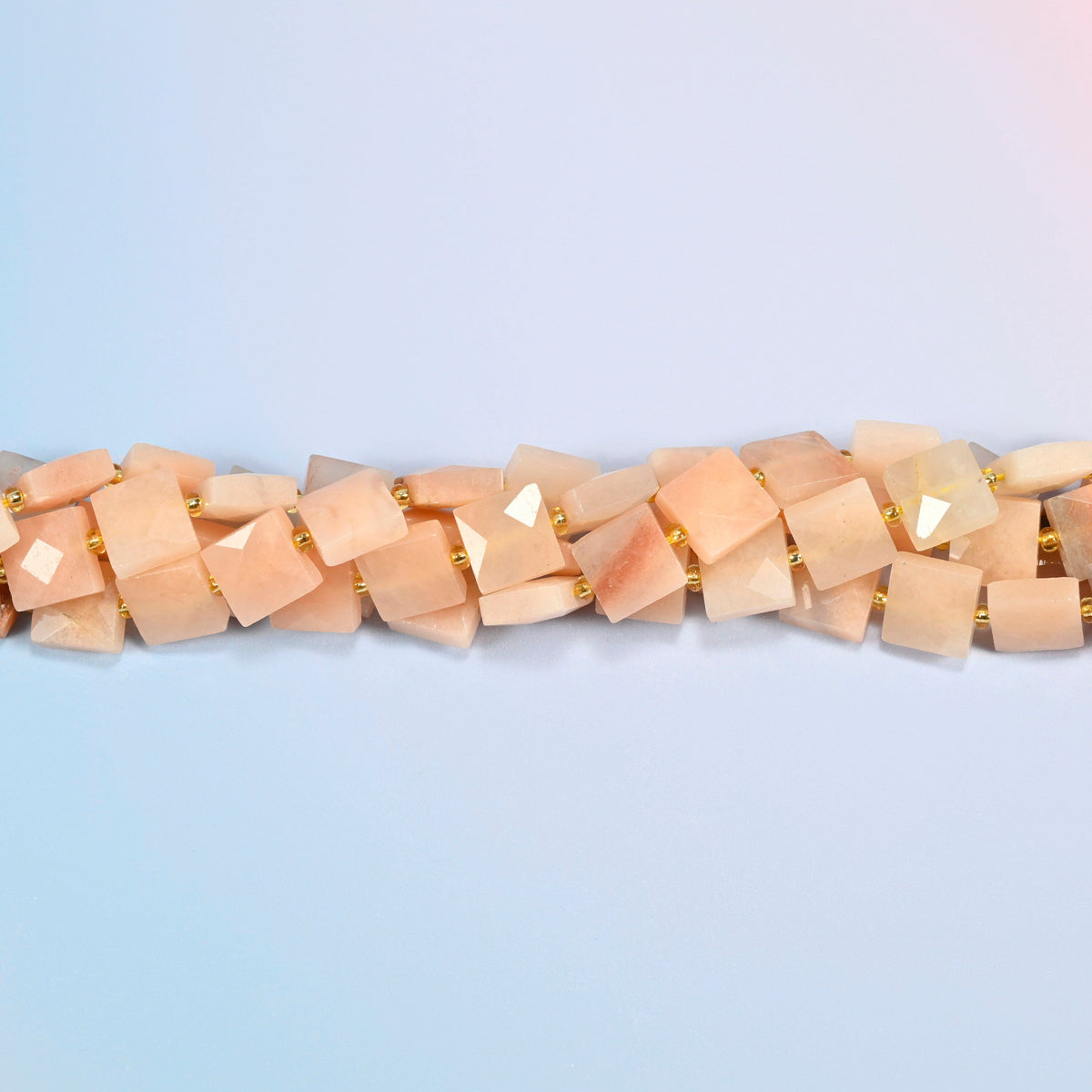 Strands of natural pink aventurine faceted flat square beads twisted together in a horizontal row
