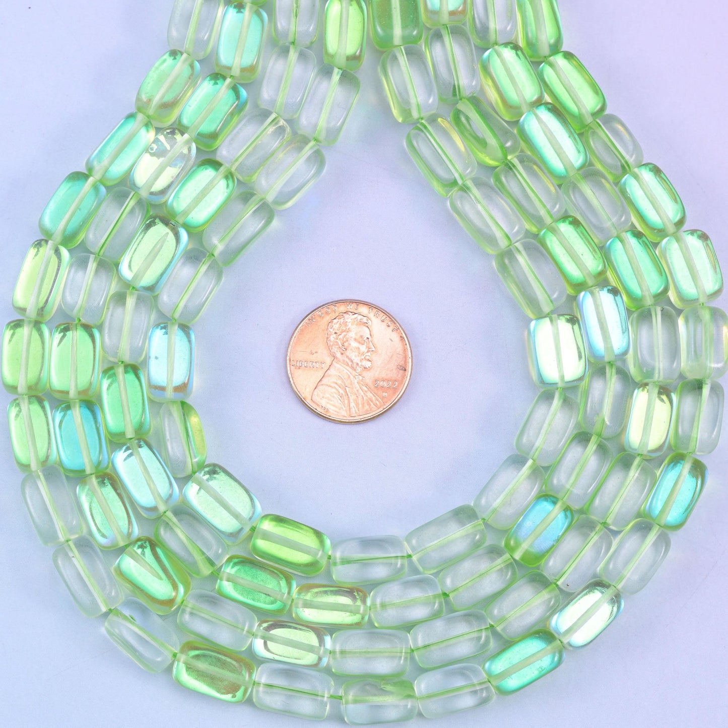 Green Mystic Aura glass beads in a rectangular cut with a glossy transparent finish, featuring a fresh lime-green shine with a subtle iridescent glow
