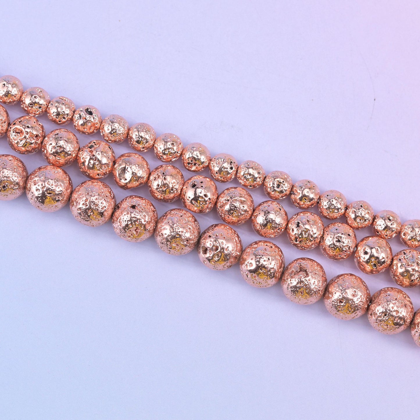 Volcano Rock Lava Beads with a deep pitted, sponge-like surface under the rose gold coating