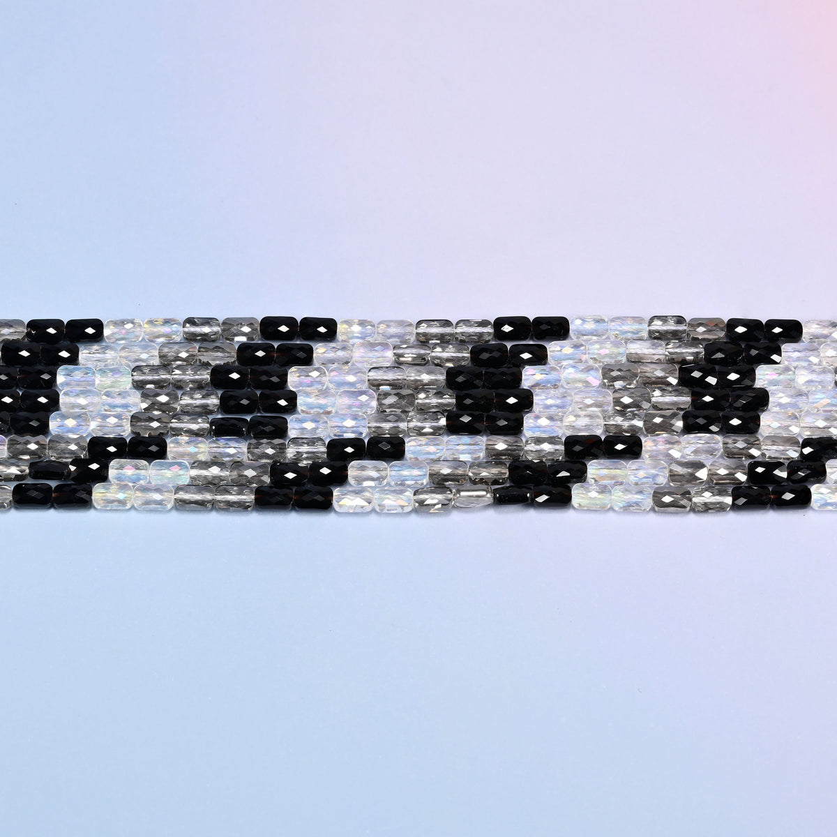 Black gray clear faceted rectangle glass beads in level rows, short rectangles lying end to end.