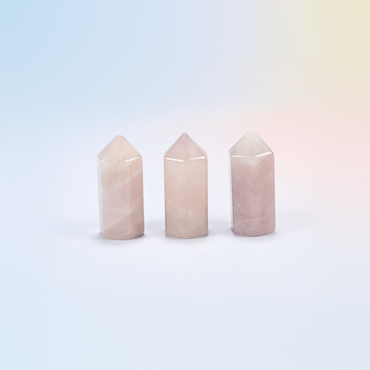 Three natural rose quartz small hexagon crystal points, light pink
