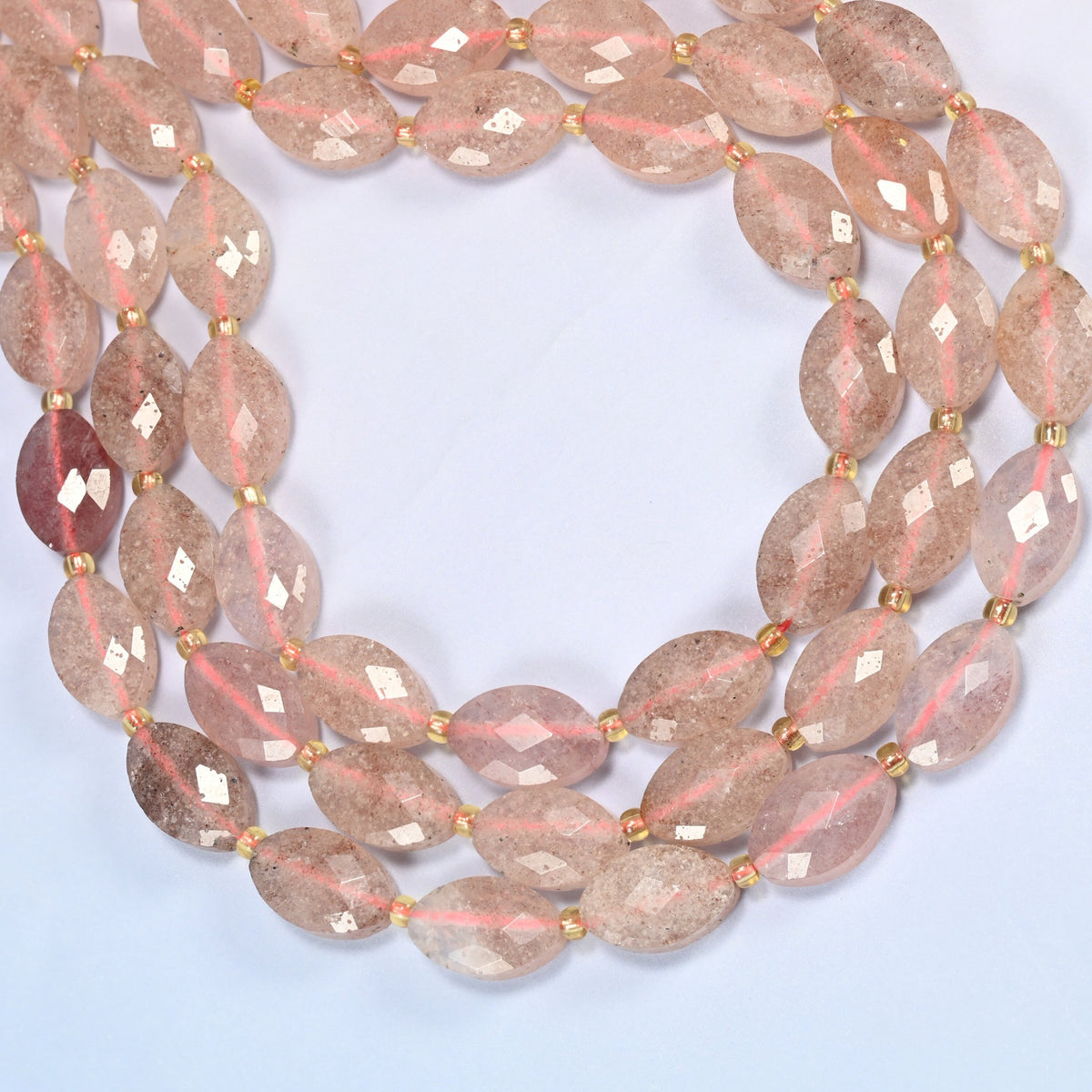 Strawberry quartz faceted flat oval beads curved into an open loop, pink beads with fine red flecks