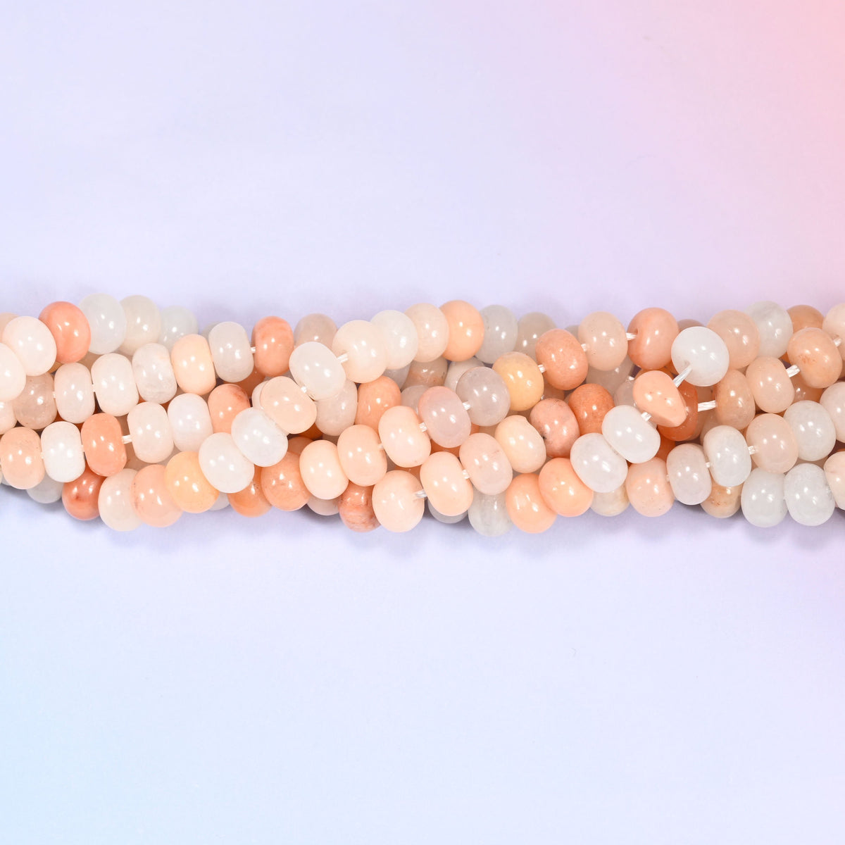 Natural Pink Aventurine rondelle beads in soft blush, peach and creamy white tones.