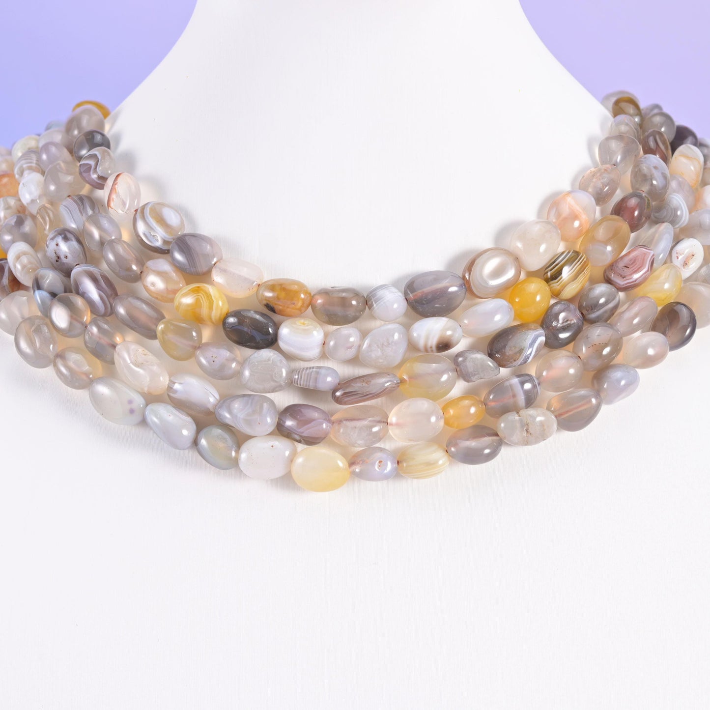 Botswana Agate pebble nuggets draped over a white neck display form