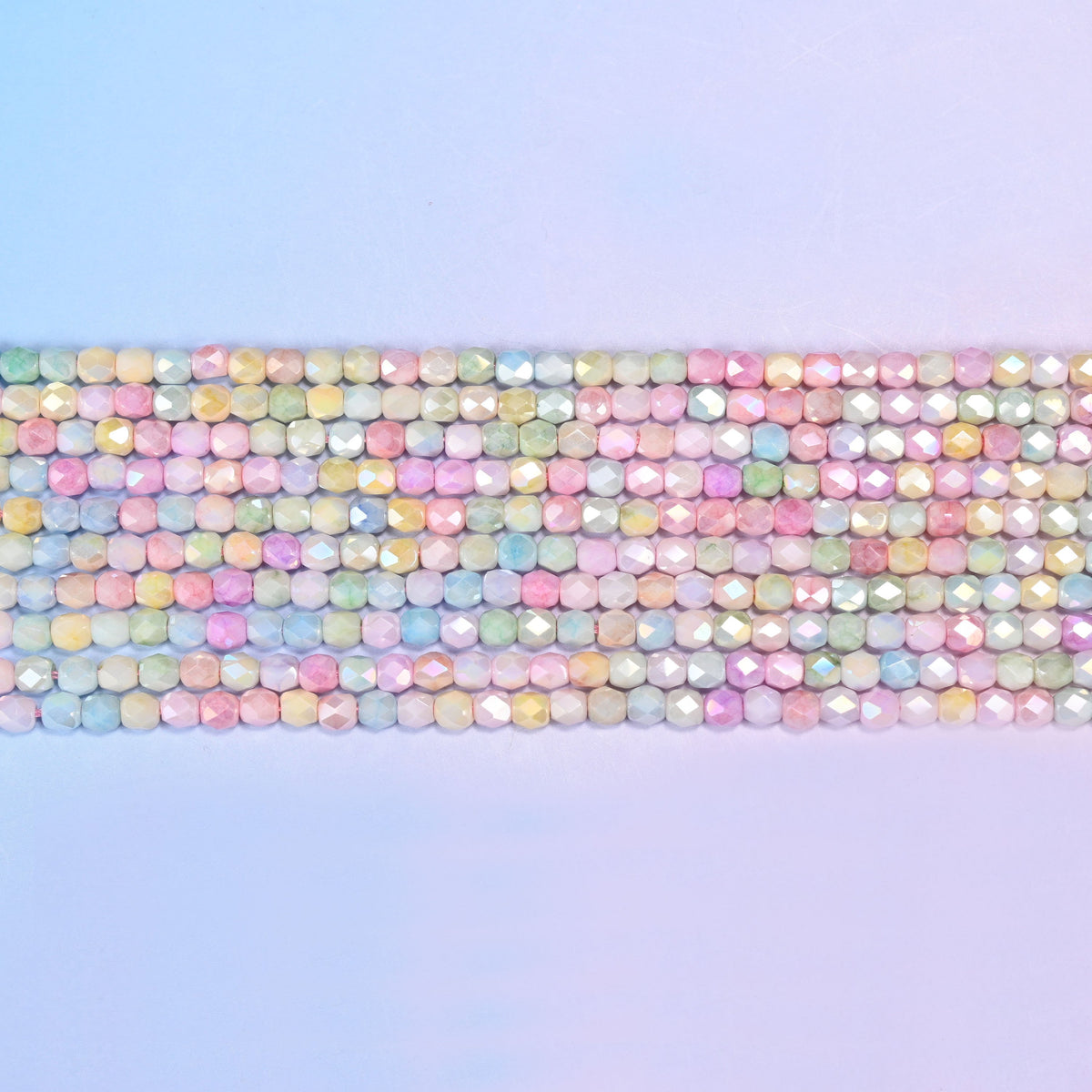 Tiny faceted barrels finished with a soft pearly sheen.