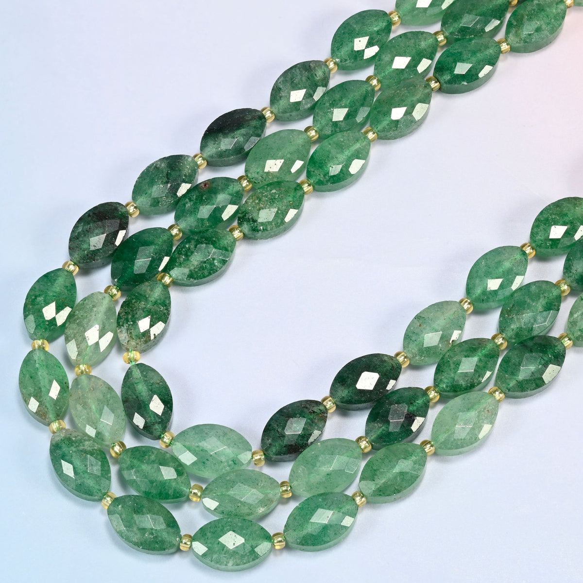 Green strawberry quartz faceted flat oval beads in several strands curved into a wide U, deep emerald and forest green stone