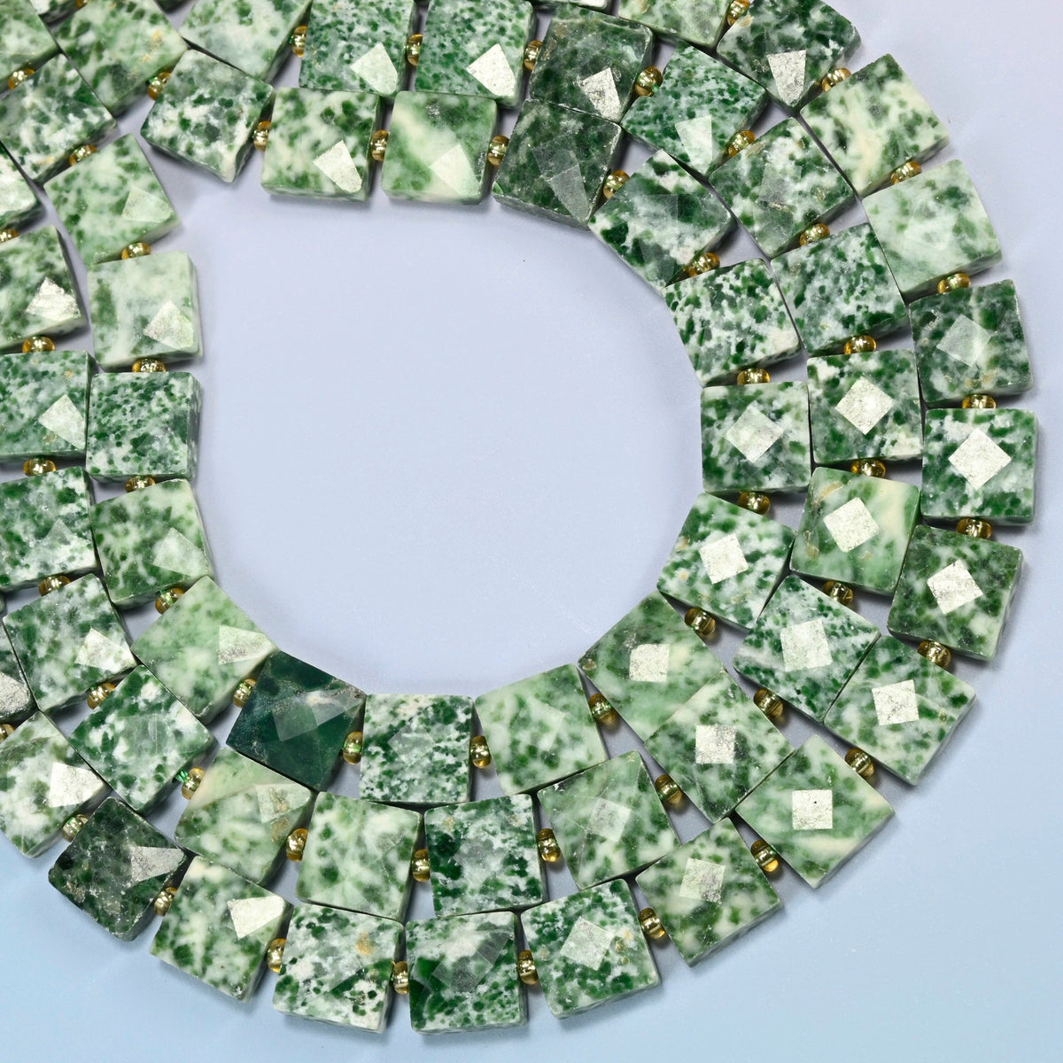 Tree agate faceted flat square beads curved into an open loop, white beads with green spots and patches