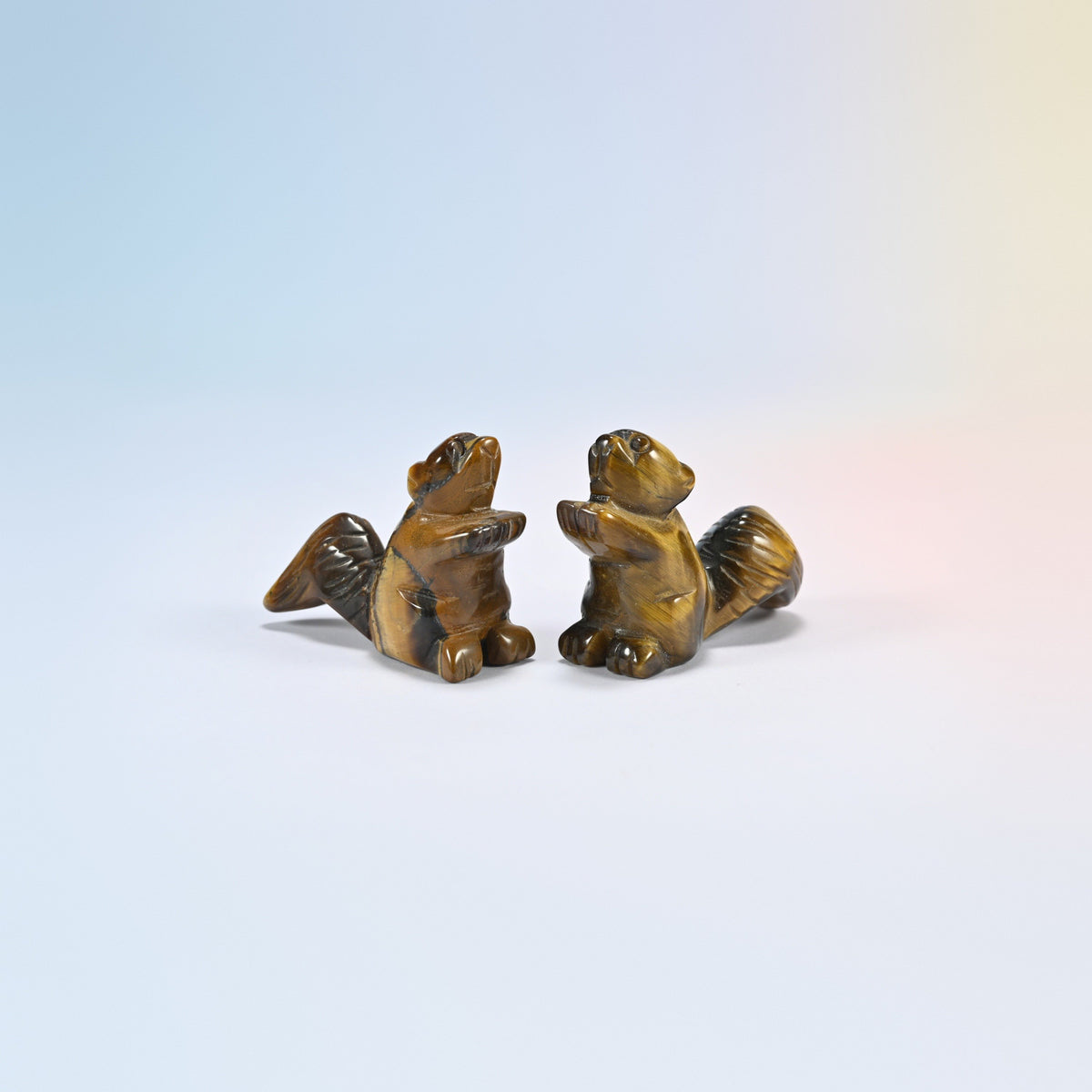 Two 2 inch natural tiger eye long tail squirrel carvings, golden brown chatoyant bands