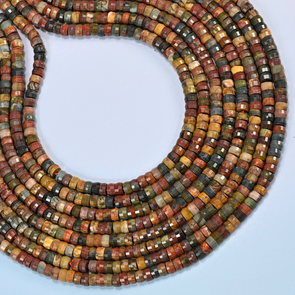Red howlite faceted heishi disc beads curved into an open loop, brick red, olive green and gray beads