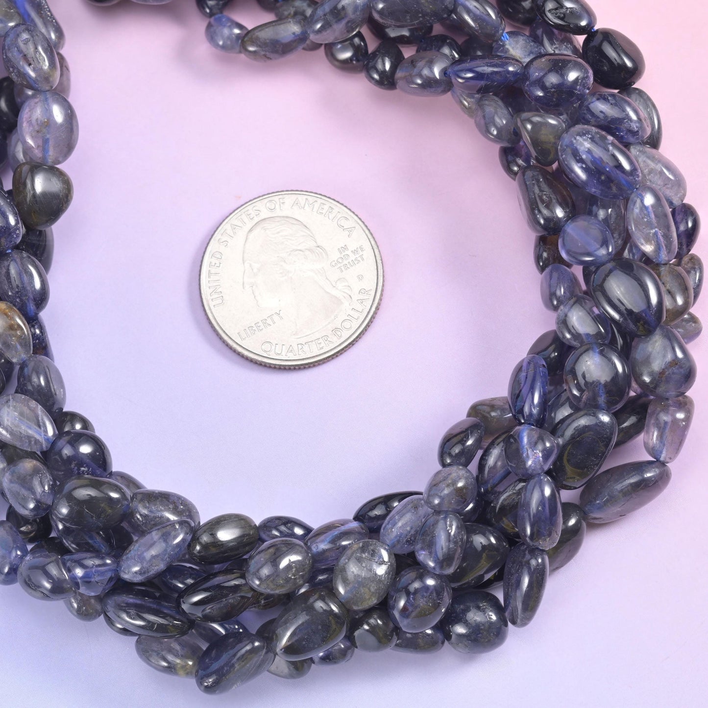 Inky blue-violet nuggets that read almost black in shadow and open to soft periwinkle when the light moves