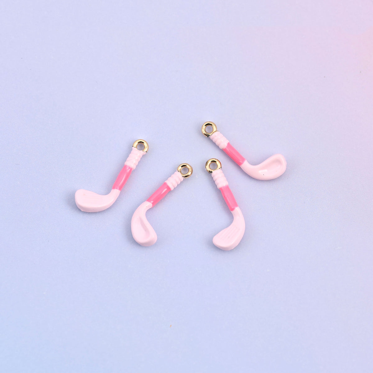 Four light pink golf club charms with pink enamel grips.