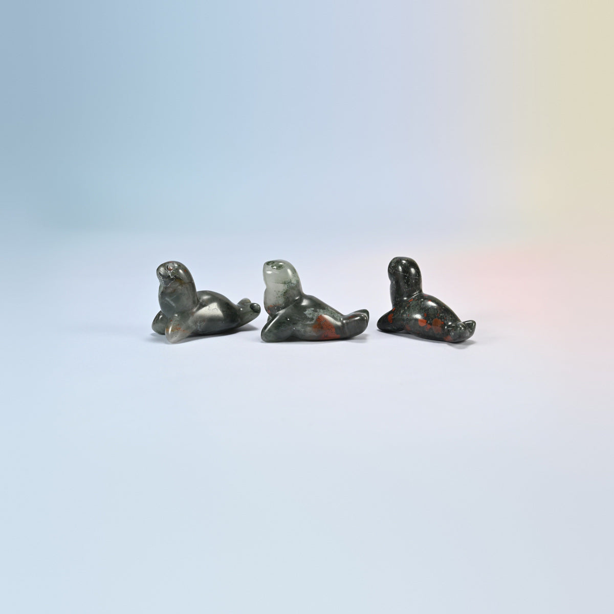 Three African bloodstone sea lion crystal carvings, 1.5 inch, dark green and gray natural stone with red patches