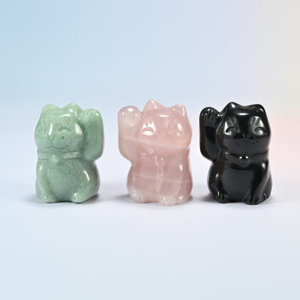 Front view of green aventurine, rose quartz and black obsidian waving cats with collar and bell