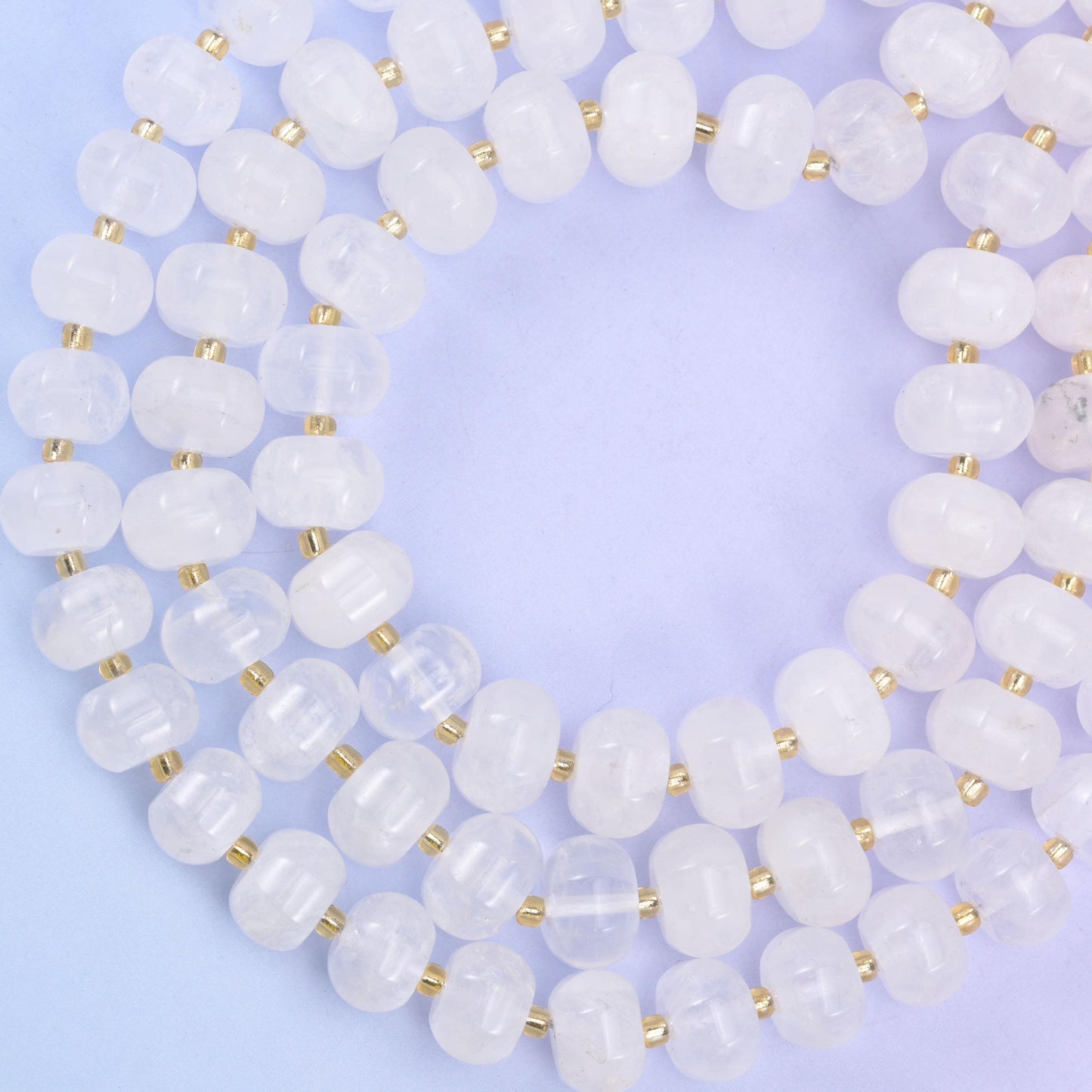 Open loop of pumpkin rondelles on lilac, beads evenly cut and closely matched