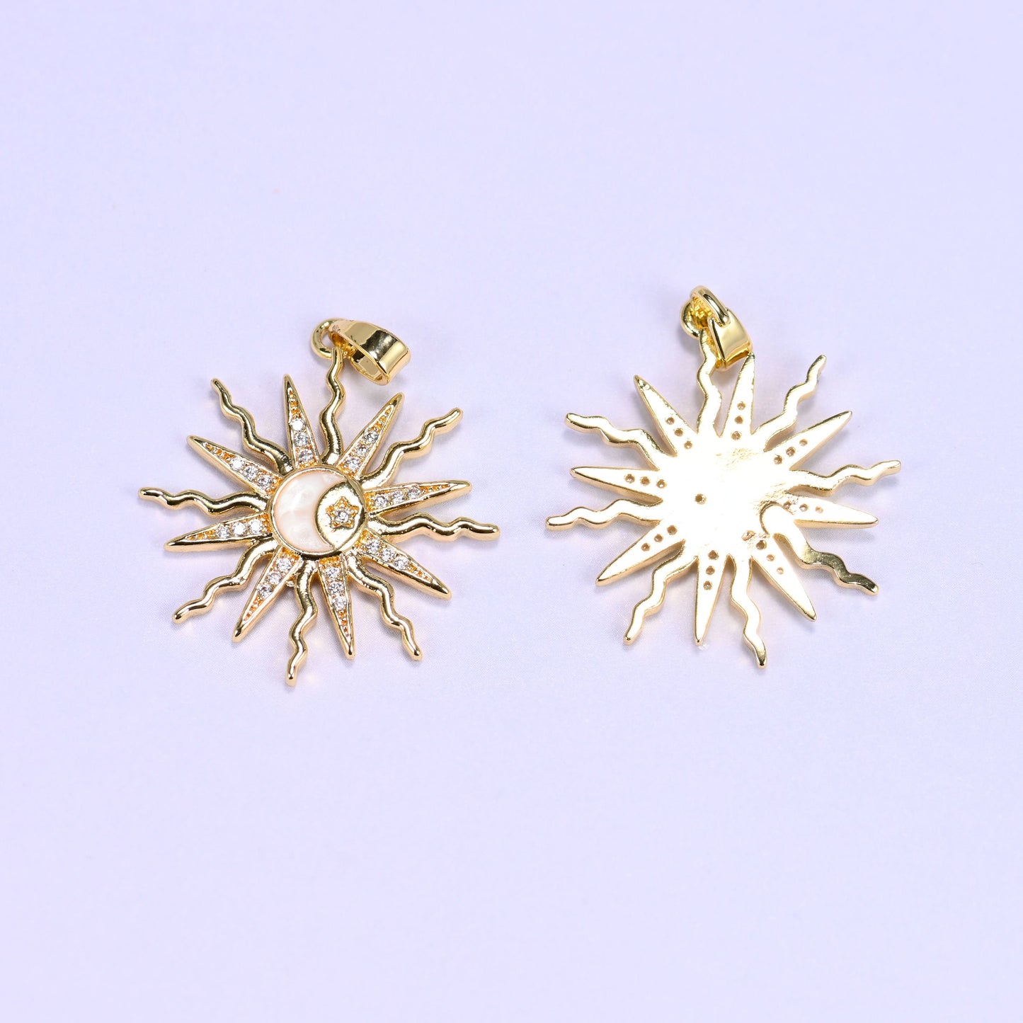 Sun charm with wavy zircon-paved rays framing an enamel moon and star center