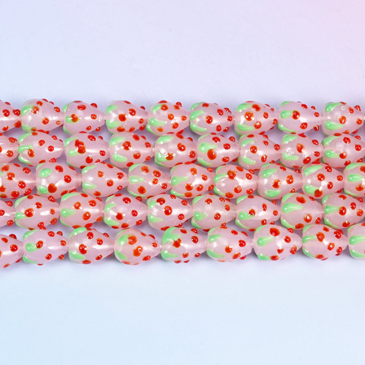 Pink Red Dots Strawberry Glass Beads in milky pink with a pale green leafy crown