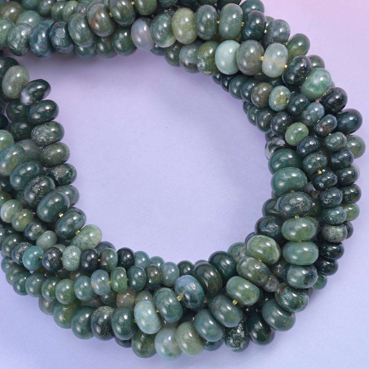 Moss agate smooth rondelle beads, several strands coiled into a loop.