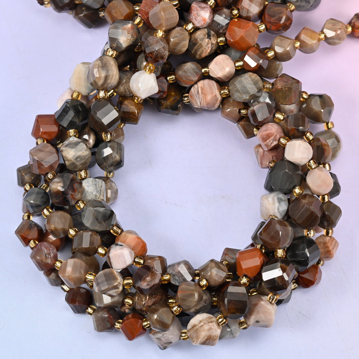 Petrified Wood faceted spiral twist beads, close view of the coiled strands mixing grey, brown, cream and rust