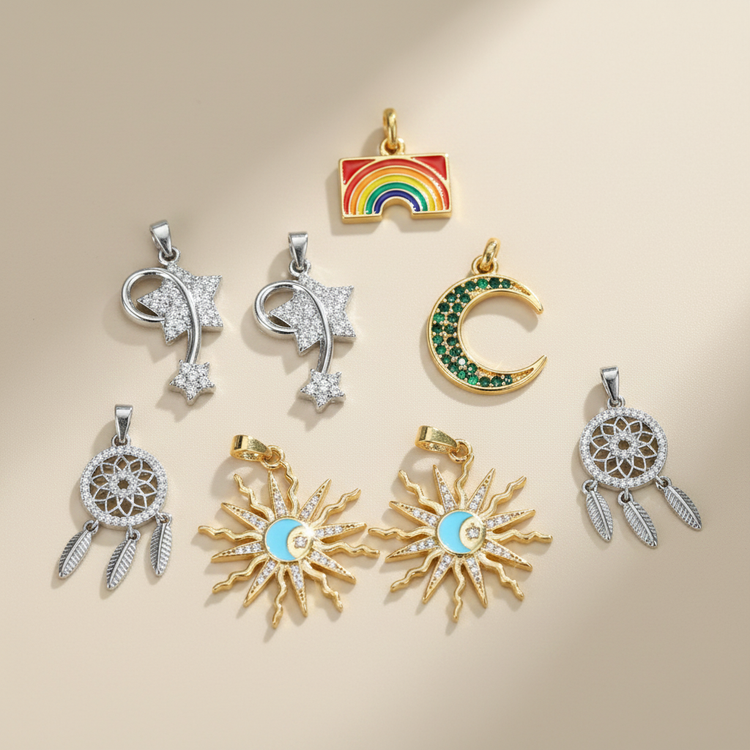 Mixed 18K gold plated celestial charms on warm ivory