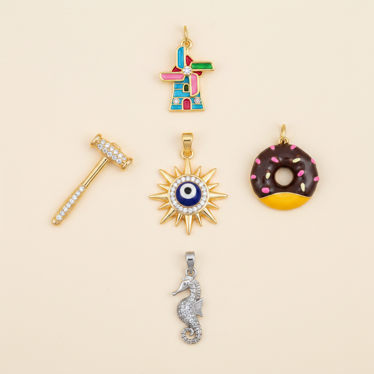 Mixed charms and pendants on warm ivory