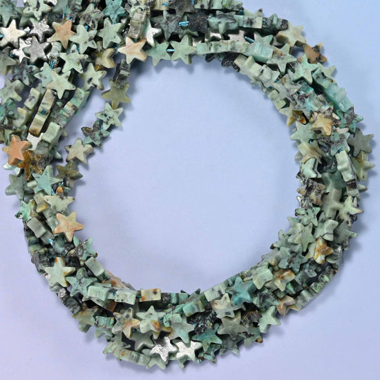 Natural African Howlite flat star beads, close view of the coiled strands in sage green with black matrix veining and tan