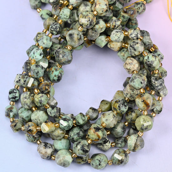 African Howlite faceted spiral twist beads, close view of the coiled strands showing sage green with black matrix speckling