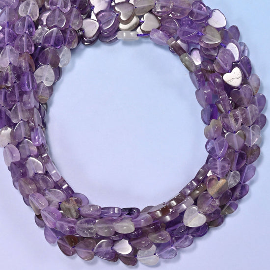 Amethyst flat heart beads, close view of the coiled strands in purple shading into grey and clear