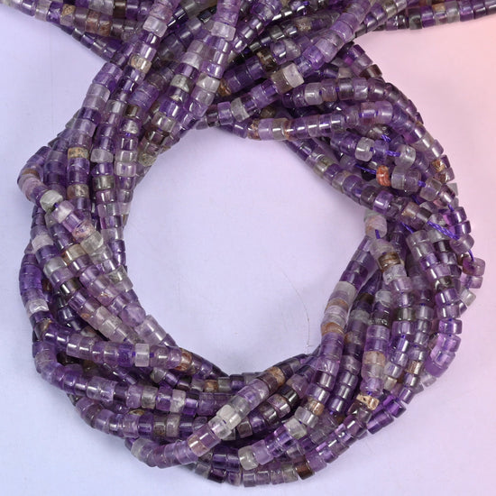 Amethyst smooth heishi disc beads, close view of the coiled strands showing purple with lighter grey-white bands
