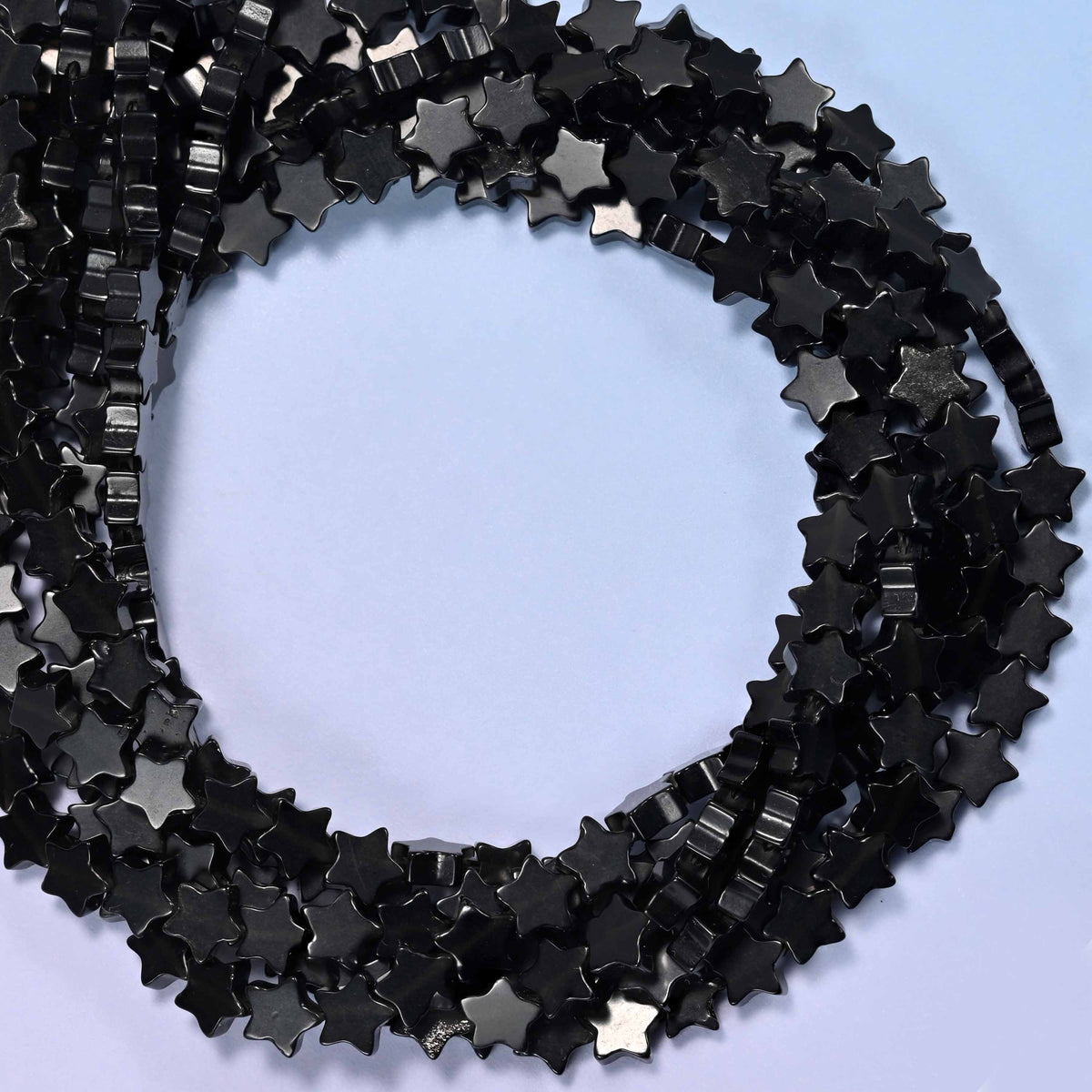 Black Obsidian flat star beads, close view of the coiled strands in glossy black
