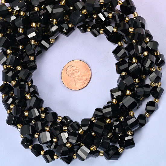 Black Onyx faceted spiral twist bead strands coiled around a US penny for size reference