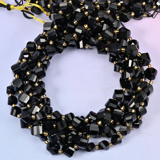 Black Onyx faceted spiral twist beads, close view of the coiled strands in glossy black with gold spacer beads