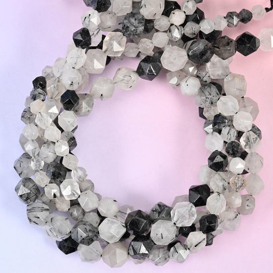 Black Rutilated Quartz faceted diamond star cut beads, close view of the coiled strands showing clear stone with black needle inclusions
