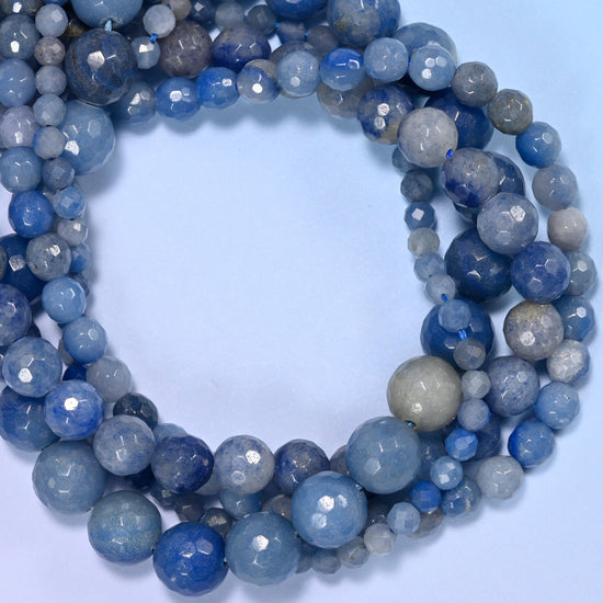Blue Aventurine faceted round beads, close view of the coiled strands showing denim and pale blue