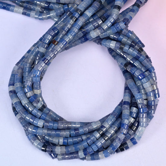 Blue Aventurine smooth heishi disc beads, close view of the coiled strands showing denim blue with lighter grey-blue banding