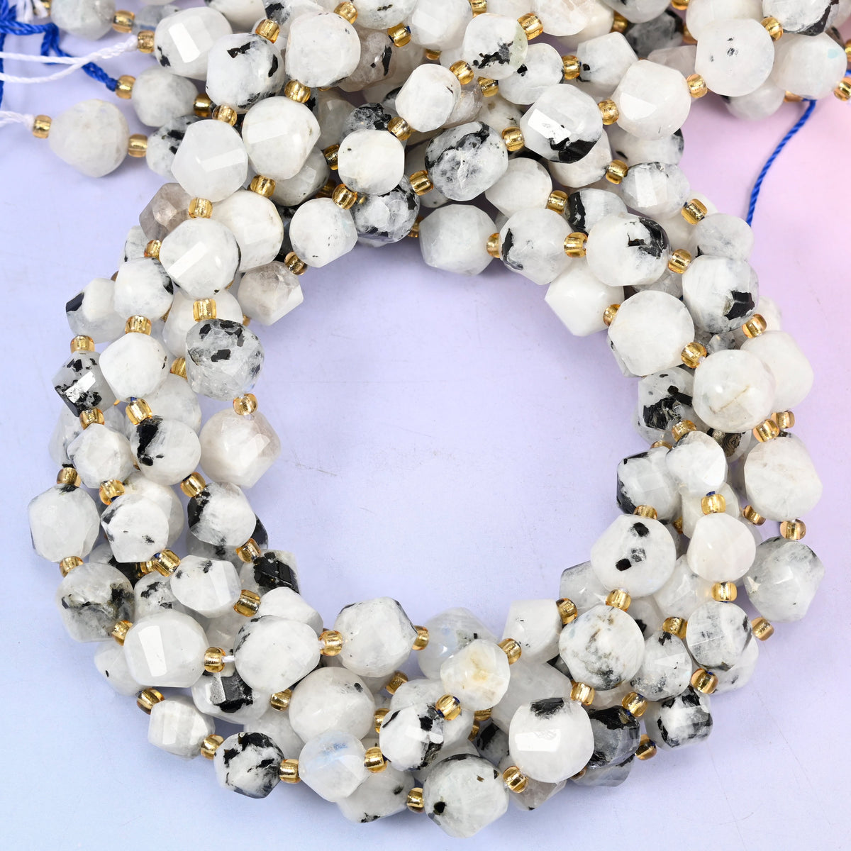 Blue Moonstone faceted spiral twist beads, close view of the coiled strands in milky white with dark speckling
