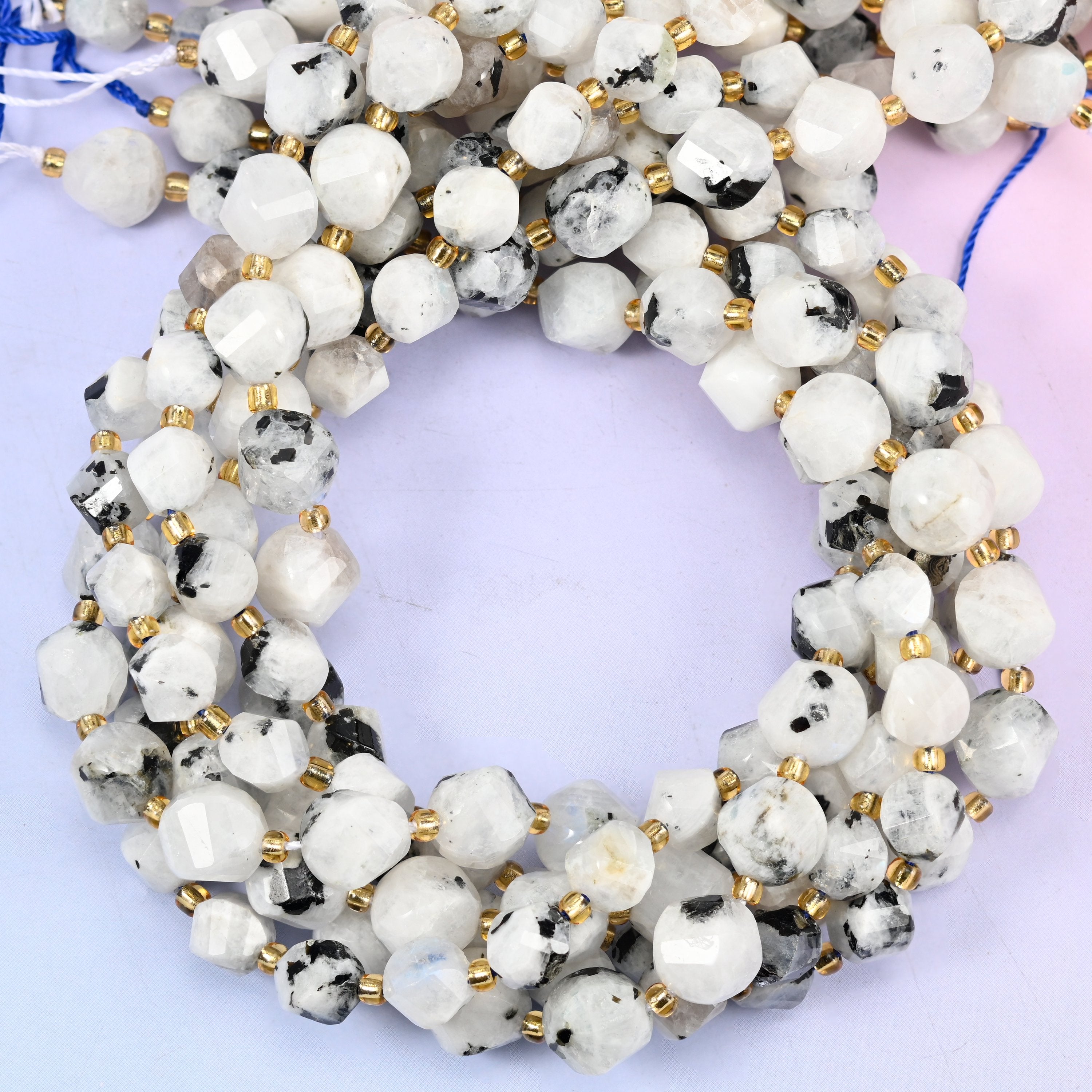 Blue Moonstone faceted spiral twist beads, close view of the coiled strands in milky white with dark speckling