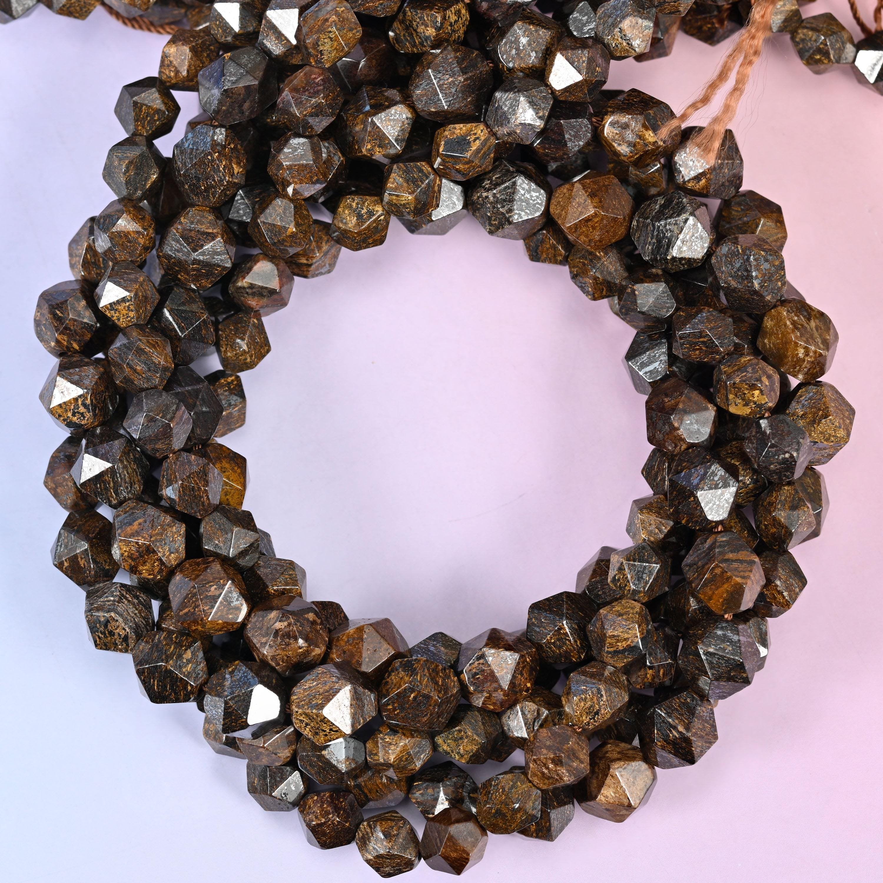 Bronzite faceted diamond star cut beads, close view of the coiled strands showing bronze brown with metallic sheen