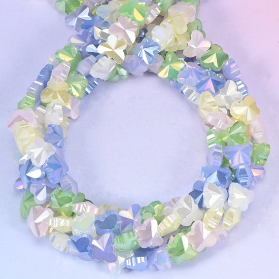 Butterfly glass beads, close view of the coiled strands mixing pastel blue, green, lilac and cream