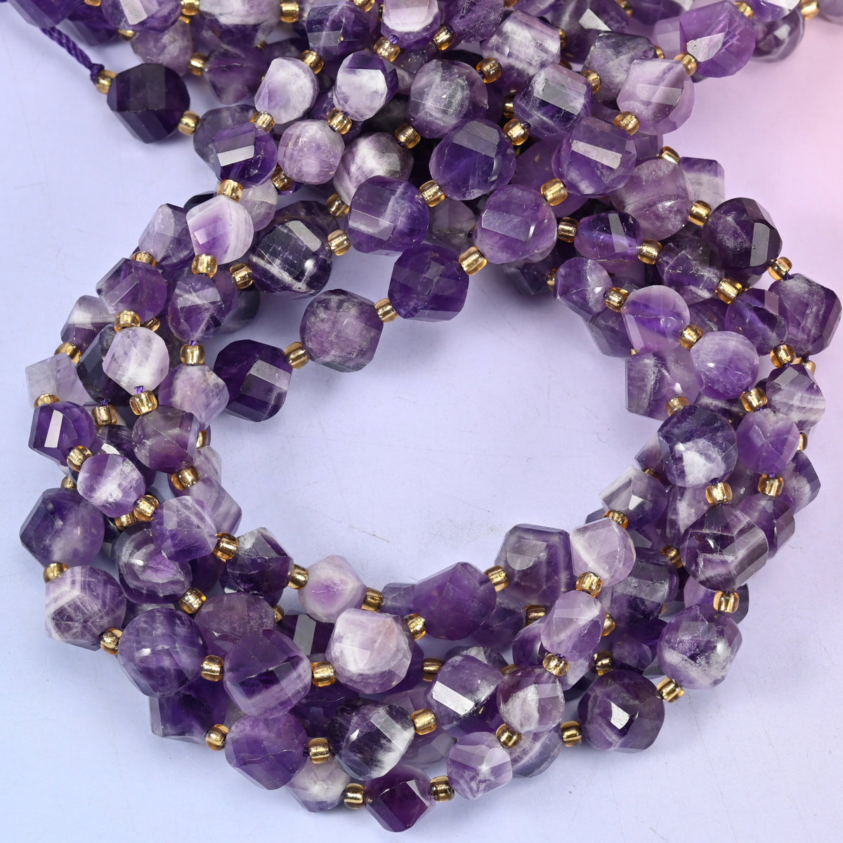 Chevron Amethyst faceted spiral twist beads, close view of the coiled strands showing purple banded with white