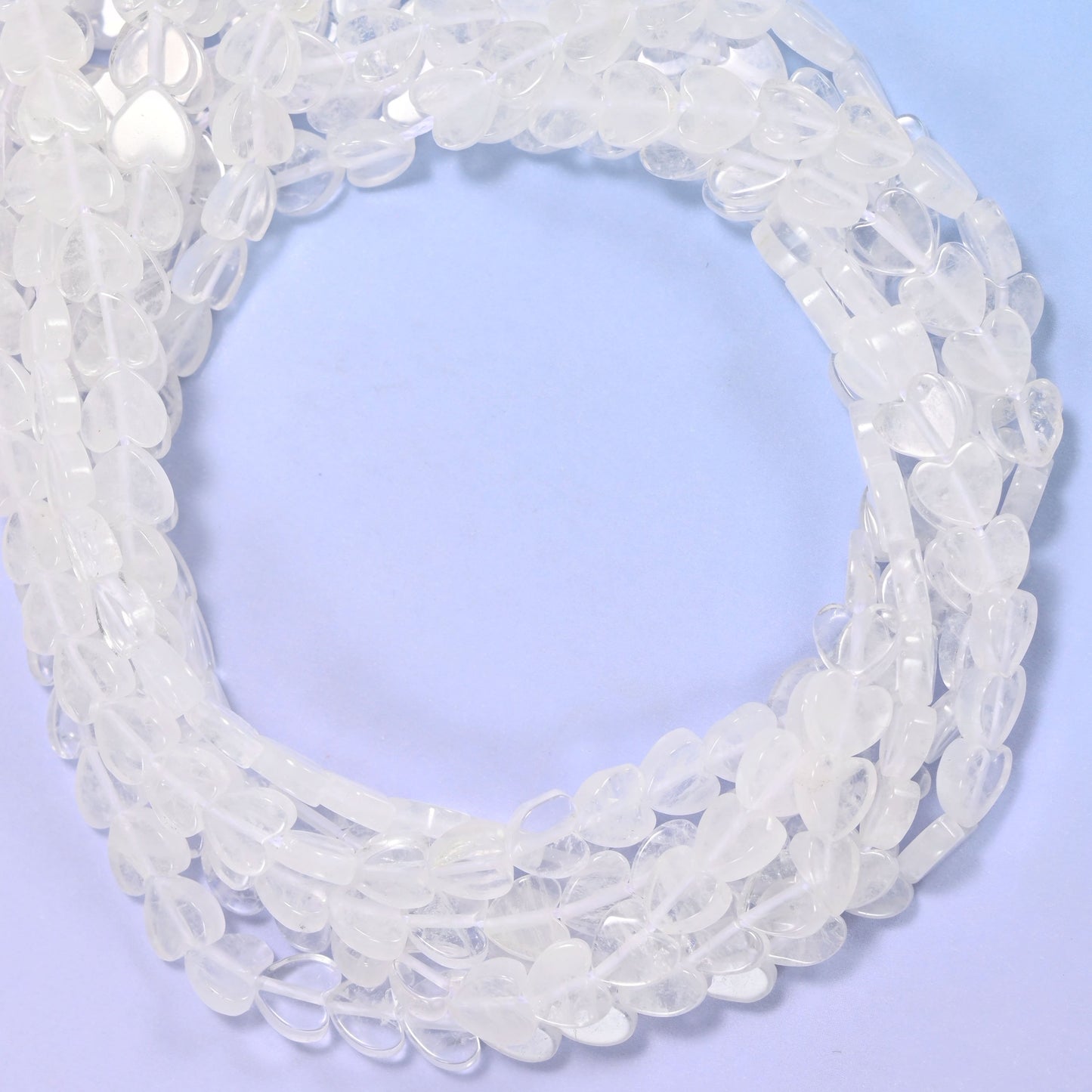 Clear Quartz flat heart beads, close view of the coiled strands of frosted clear hearts