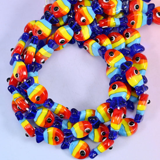 Colorful Fish glass beads, close view of the coiled strands striped in red, orange, yellow and blue